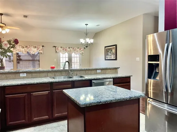 a kitchen with granite countertop counter top space cabinets and stainless steel appliances
