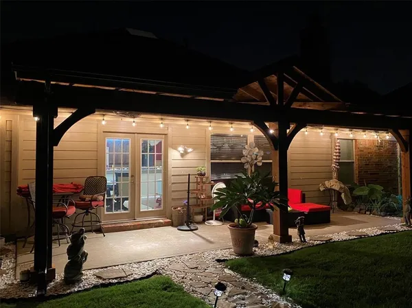 a view of a porch with furniture and garden