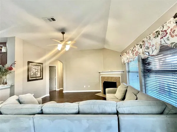 a living room with furniture and a fireplace