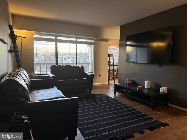a living room with furniture and a floor to ceiling window