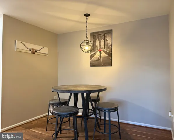 a view of a room with a table and chairs