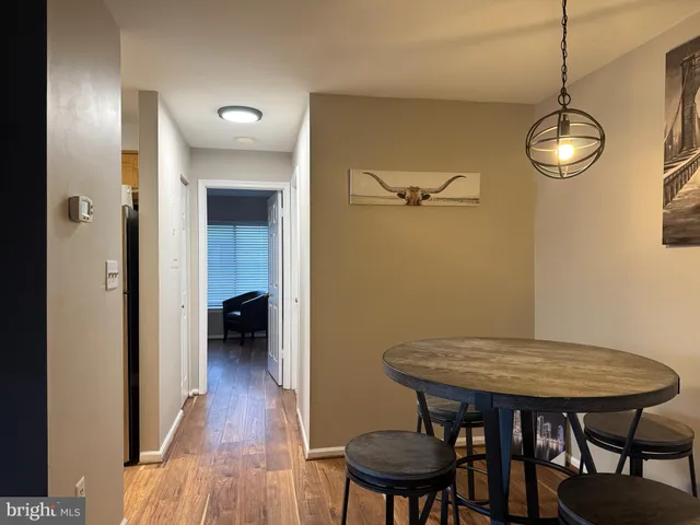 a view of a room with furniture and wooden floor
