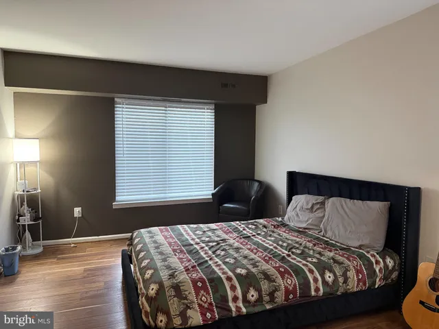 a bedroom with a bed and window