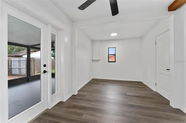 wooden floor in an empty room with a window