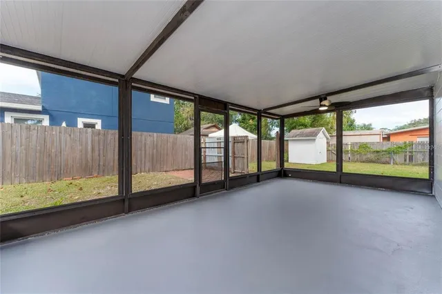 a view of room with wooden floor and iron stairs
