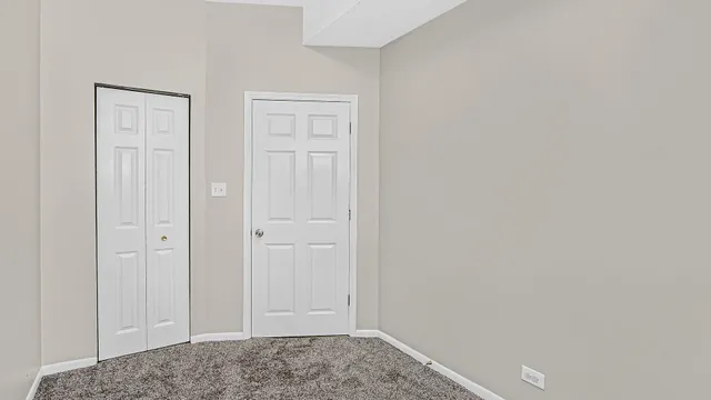 an empty room with closet area