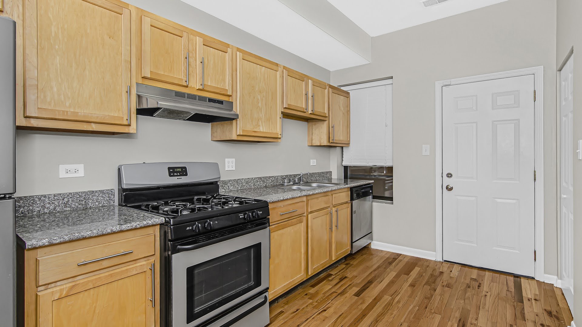 4055 South Calumet Avenue, Unit 3 Chicago, IL 60653 - Photo 2 of 15 a kitchen with stainless steel appliances granite countertop a stove and a white cabinets