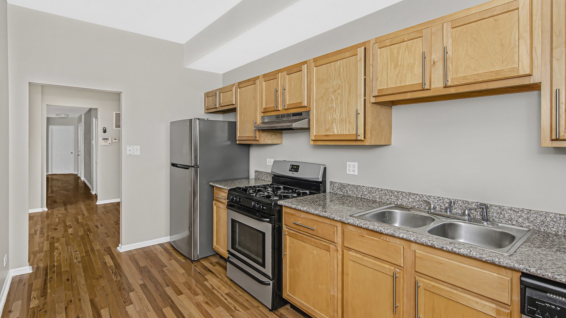4055 South Calumet Avenue, Unit 3 Chicago, IL 60653 - Photo 3 of 15 a kitchen with granite countertop a sink stove and refrigerator