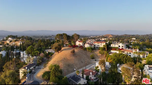 an aerial view of residential houses and outdoor space