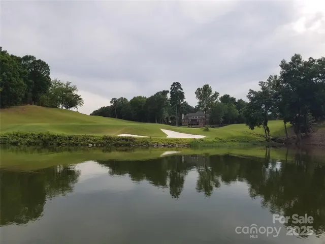 a view of a lake with houses in the back