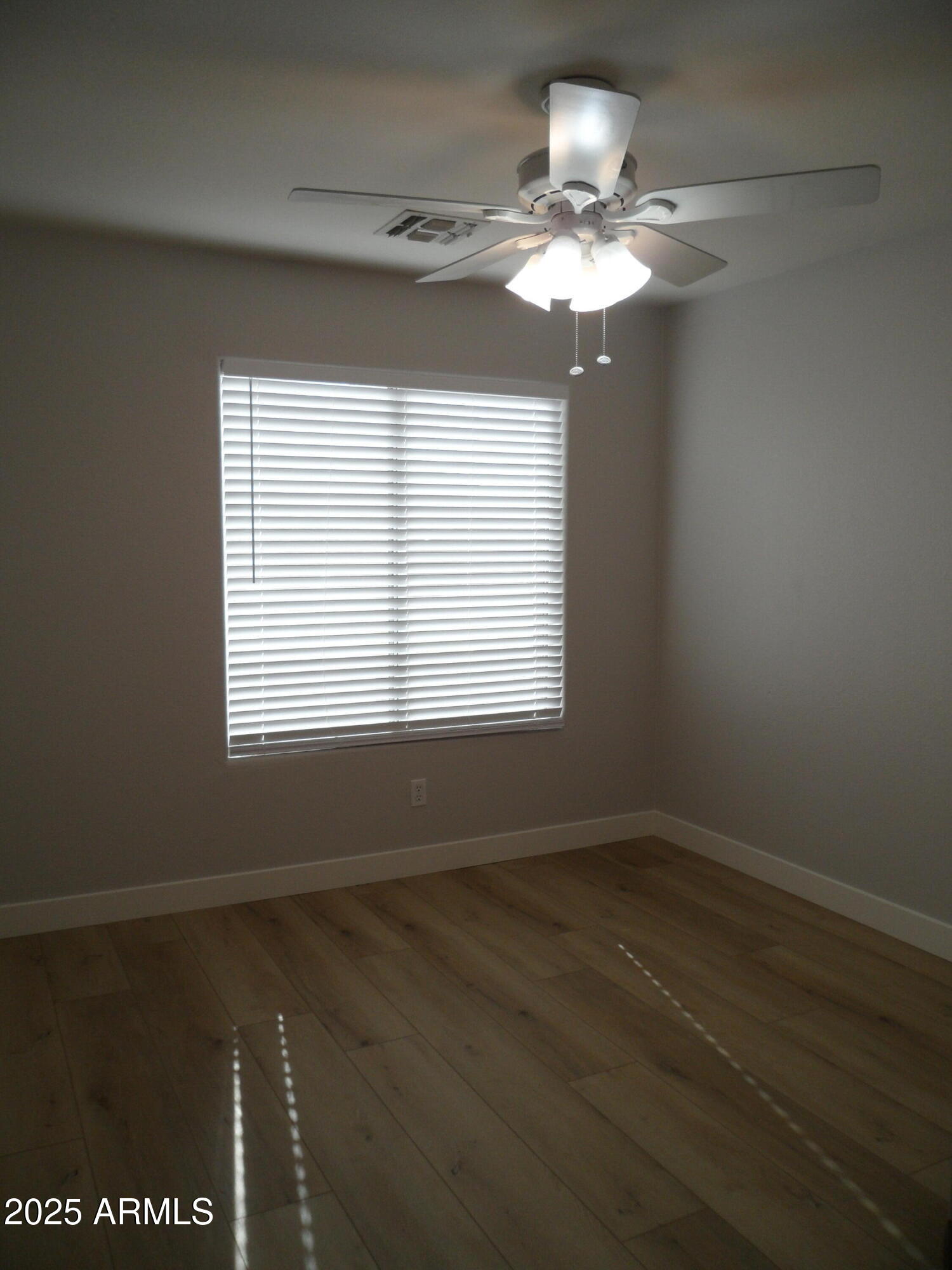 3812 South Seton Avenue Gilbert, AZ 85297 - Photo 11 of 18 a view of a livingroom with a chandelier fan and a window