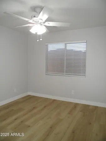 a view of a livingroom with a chandelier fan and a window
