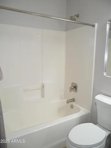 a bathroom with a sink a toilet a mirror and vanity