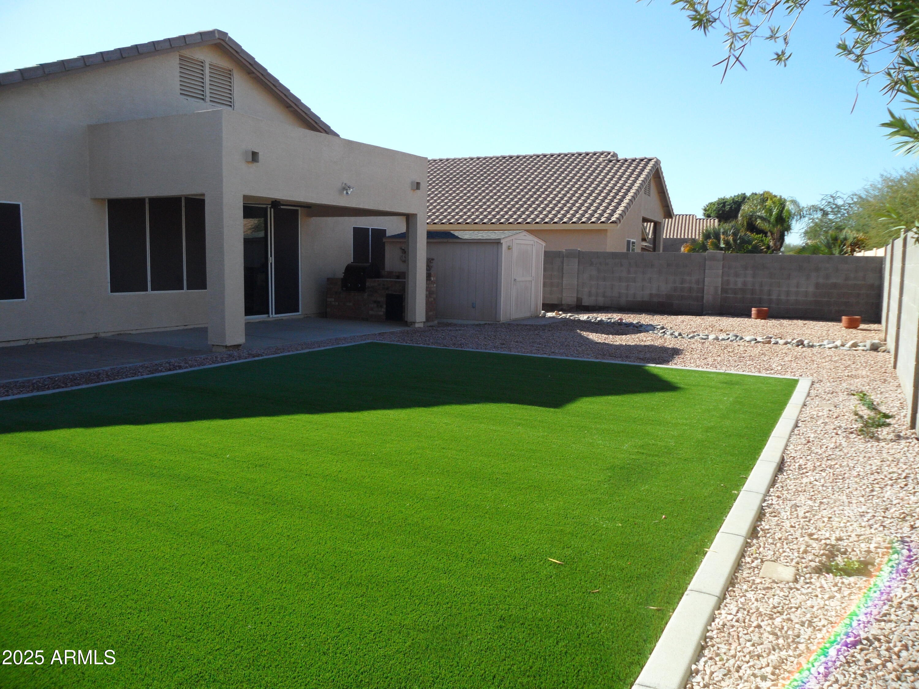 3812 South Seton Avenue Gilbert, AZ 85297 - Photo 15 of 18 a front view of a house with a yard and garage
