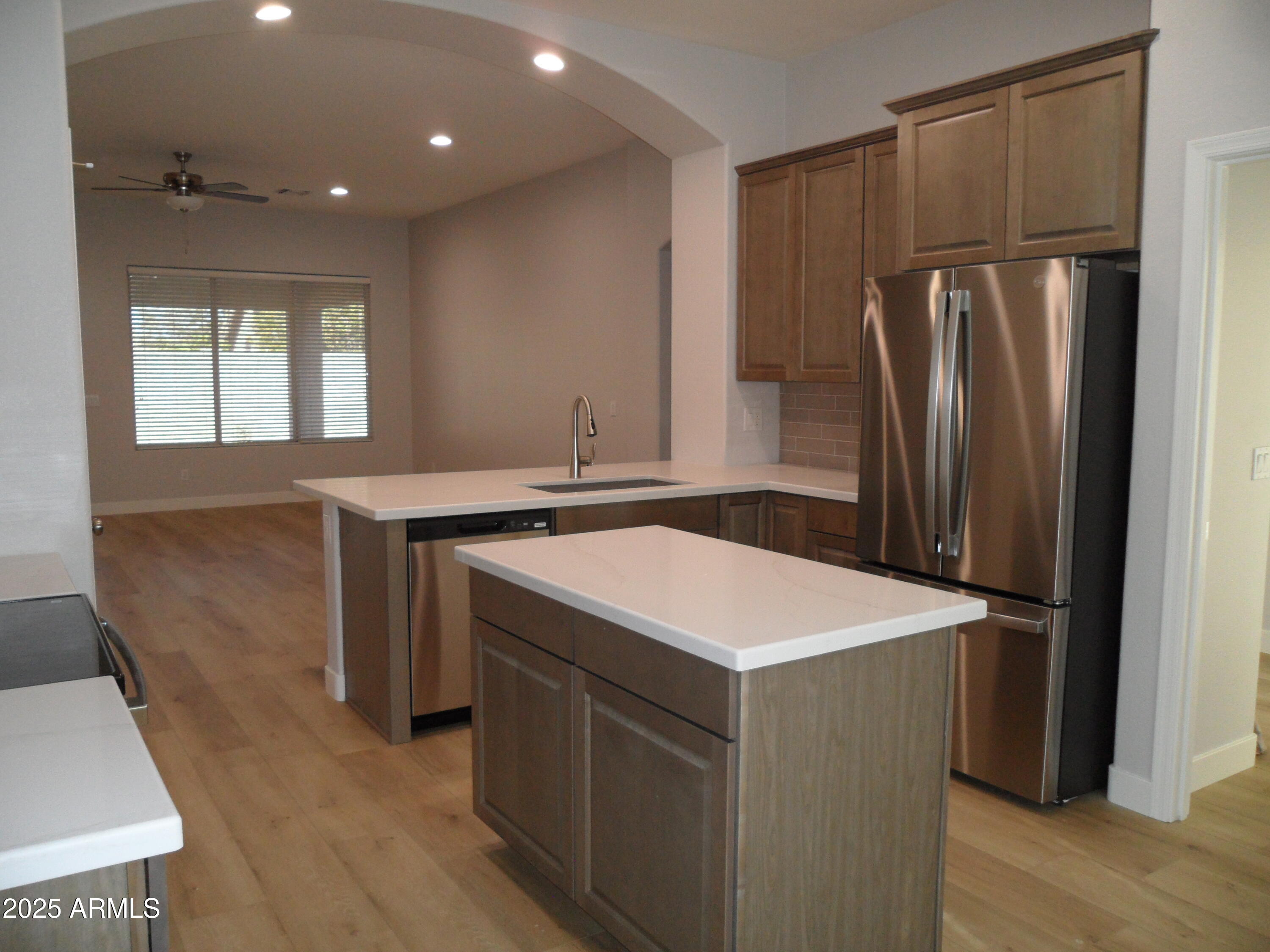 3812 South Seton Avenue Gilbert, AZ 85297 - Photo 3 of 18 a kitchen with a sink a refrigerator and a stove