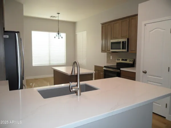 a kitchen with a sink a refrigerator and a stove