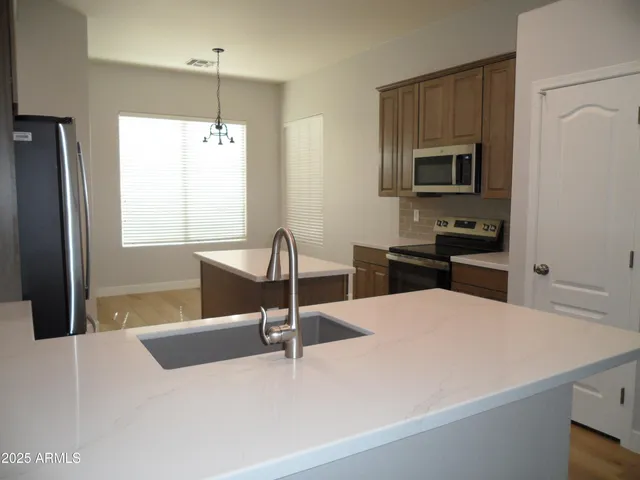 a kitchen with a sink a refrigerator and a stove