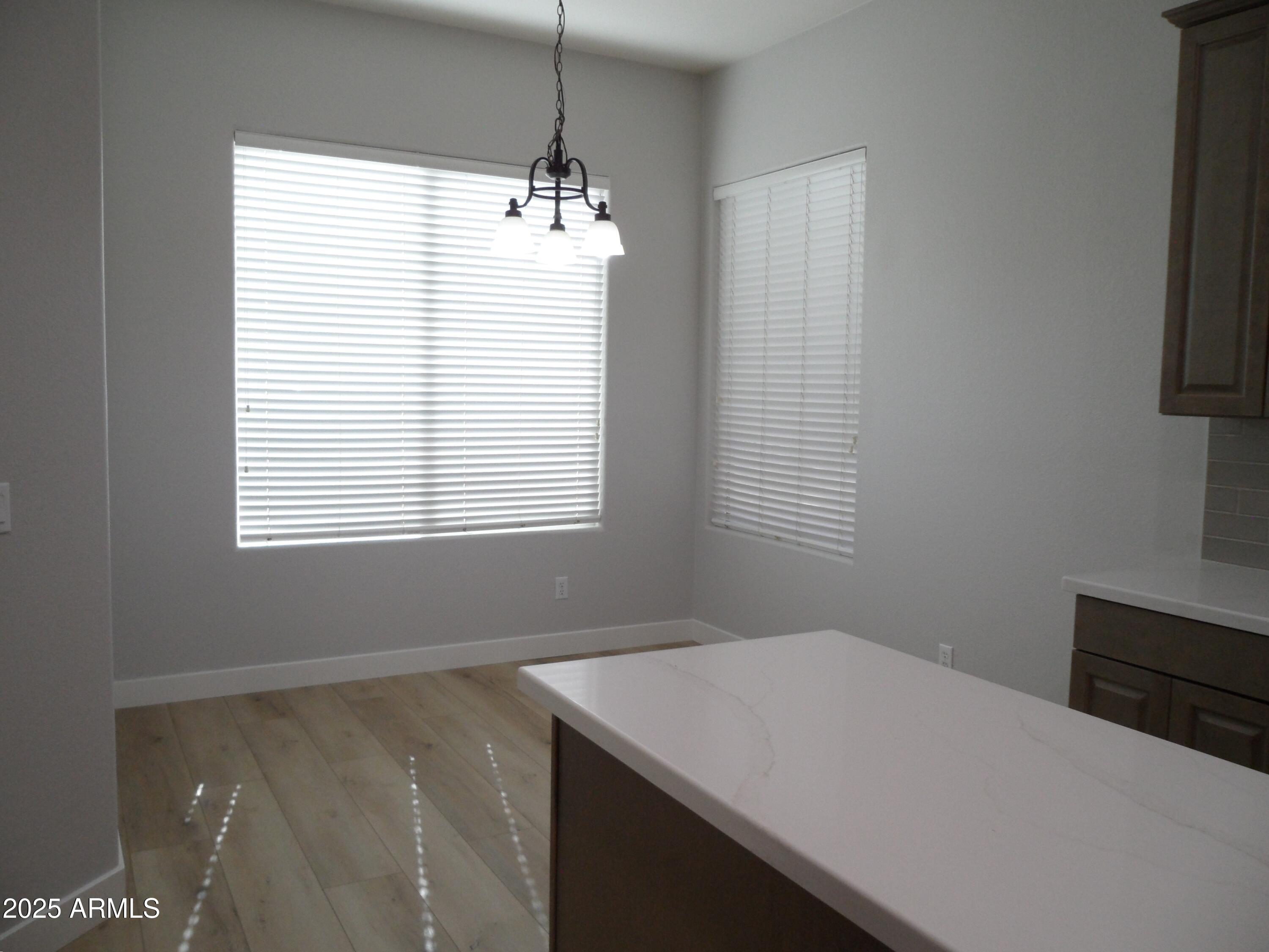 3812 South Seton Avenue Gilbert, AZ 85297 - Photo 5 of 18 a room with window and a chandelier