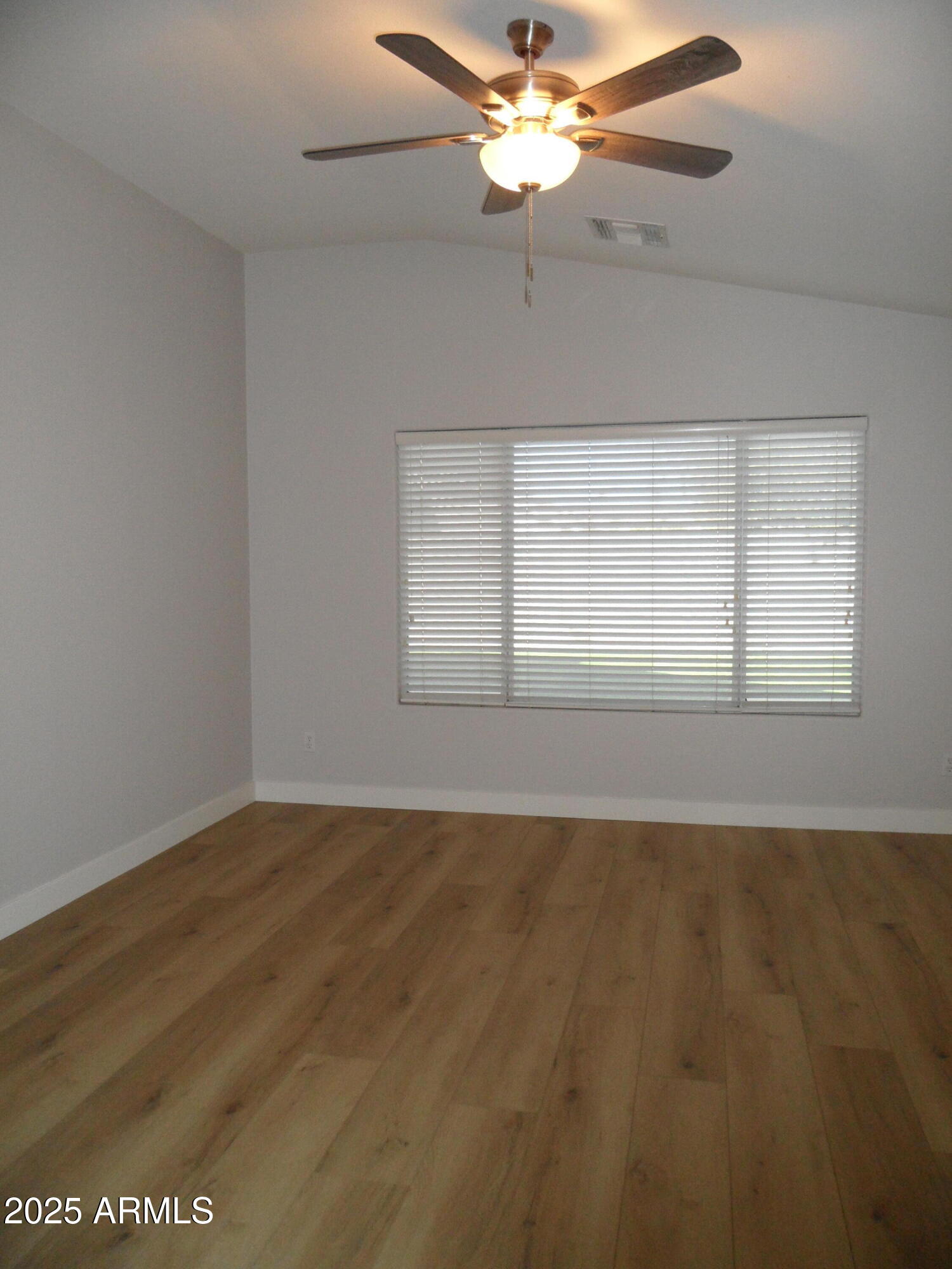 3812 South Seton Avenue Gilbert, AZ 85297 - Photo 7 of 18 an empty room with wooden floor fan and windows