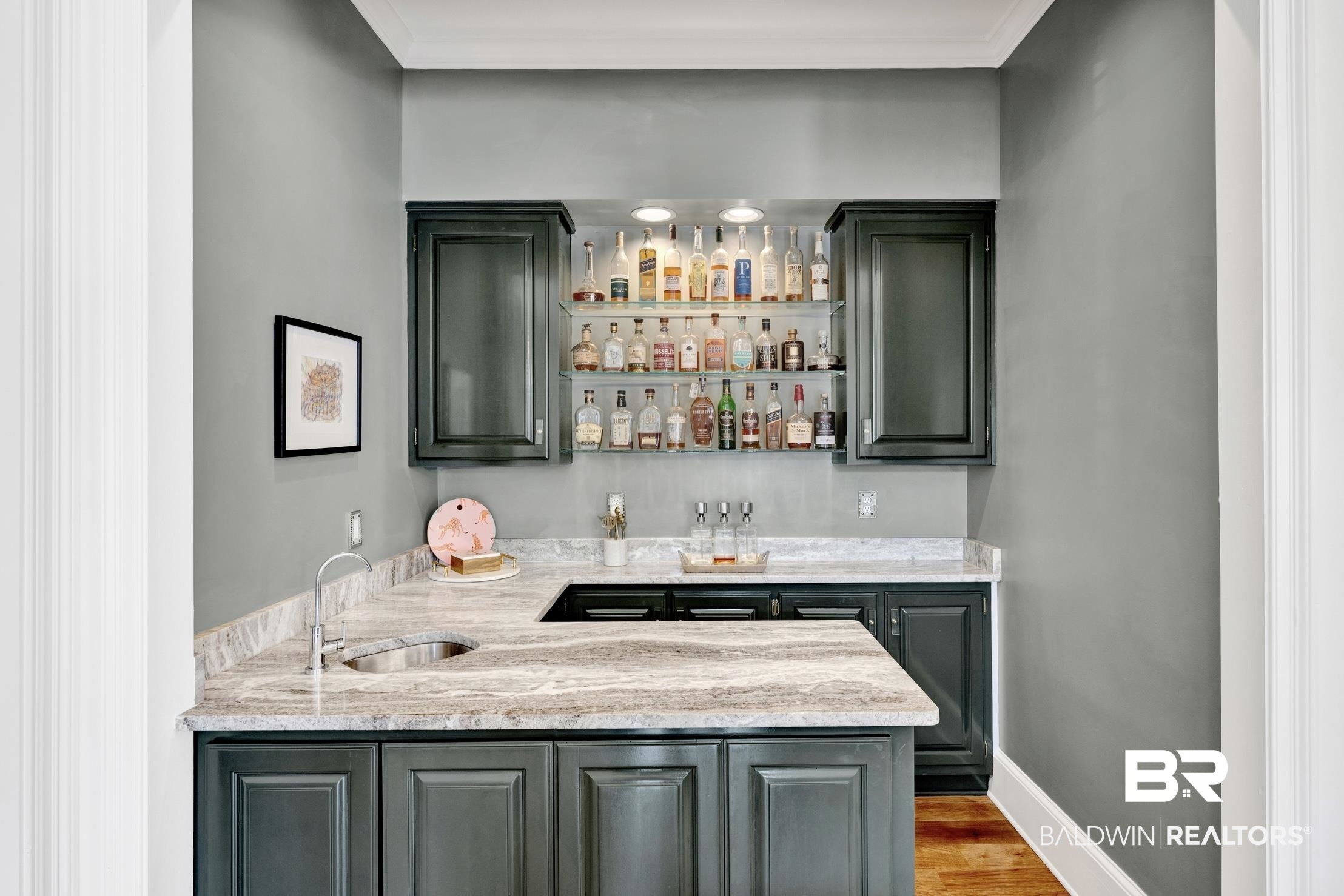 4 Savannah Court Mobile, AL 36608 - Photo 27 of 32 Indoor wet bar with light stone counters, open shelves, wood finished floors, and ornamental molding