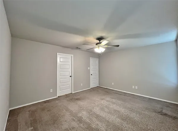 a view of an empty room with closet