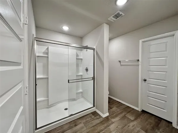 a bathroom with a glass shower door