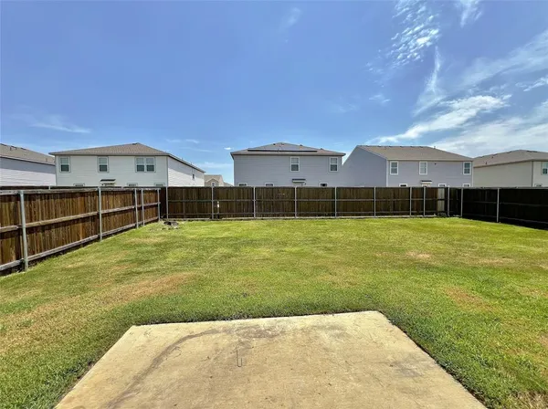 a view of a big yard with a small pool and a fire pit