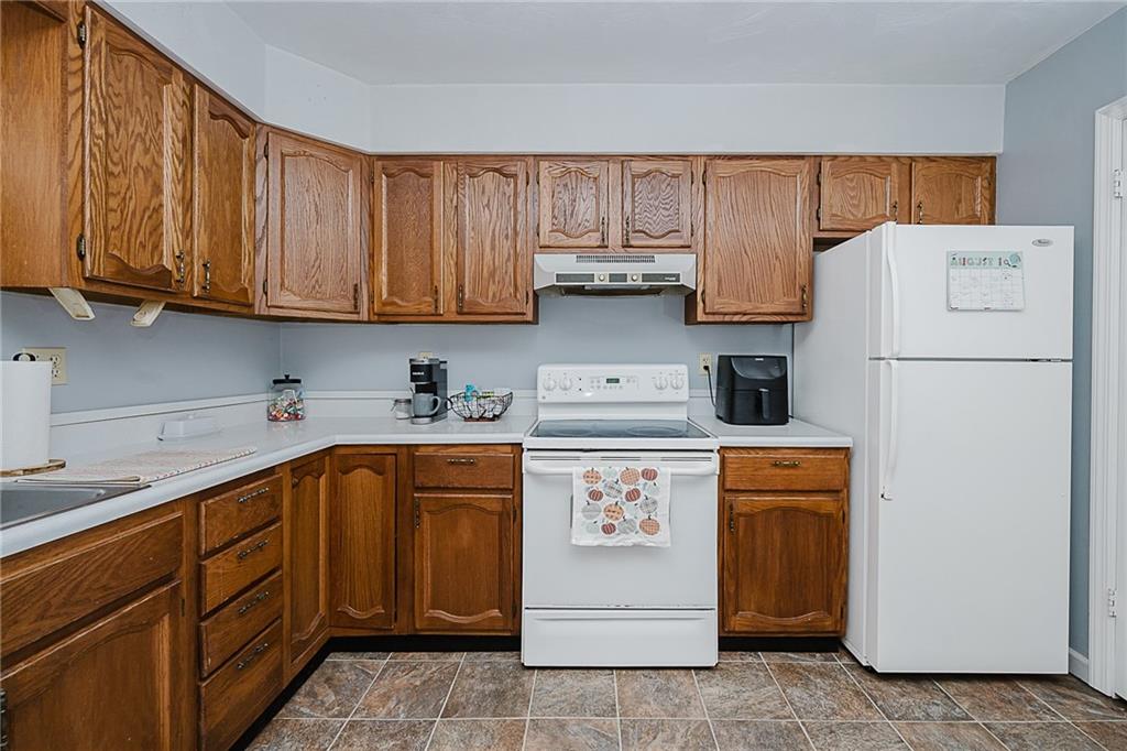 4852 Lucerne Road Indiana, PA 15701 - Photo 6 of 22 a kitchen with a sink a refrigerator and cabinets