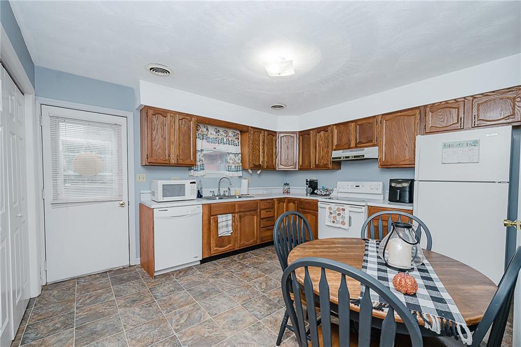 4852 Lucerne Road Indiana, PA 15701 - Photo 7 of 22 a kitchen with stainless steel appliances granite countertop a stove top oven a sink dishwasher and white cabinets