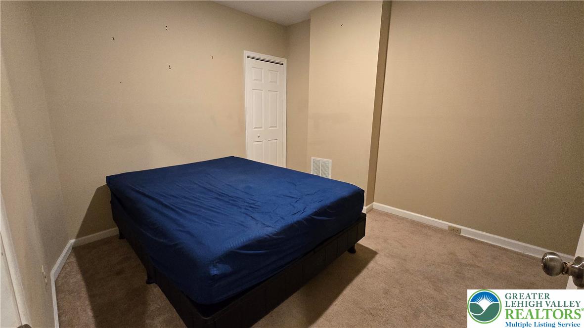 1116 West Maple Street Allentown, PA 18102 - Photo 19 of 38 a bed sitting in a bedroom next to a cabinet