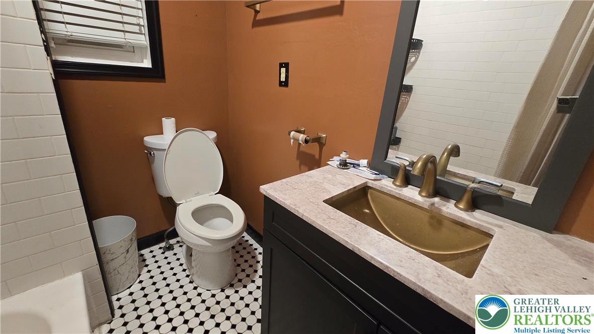 1116 West Maple Street Allentown, PA 18102 - Photo 24 of 38 a bathroom with a sink a toilet and a mirror