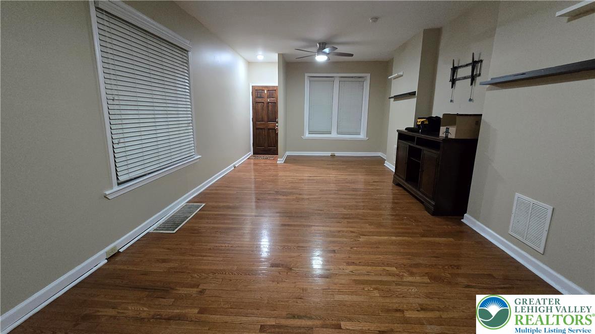 1116 West Maple Street Allentown, PA 18102 - Photo 4 of 38 a view of a hallway with wooden floor and stairs