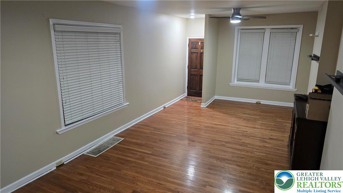 1116 West Maple Street Allentown, PA 18102 - Photo 7 of 38 a view of an empty room with wooden floor and a window