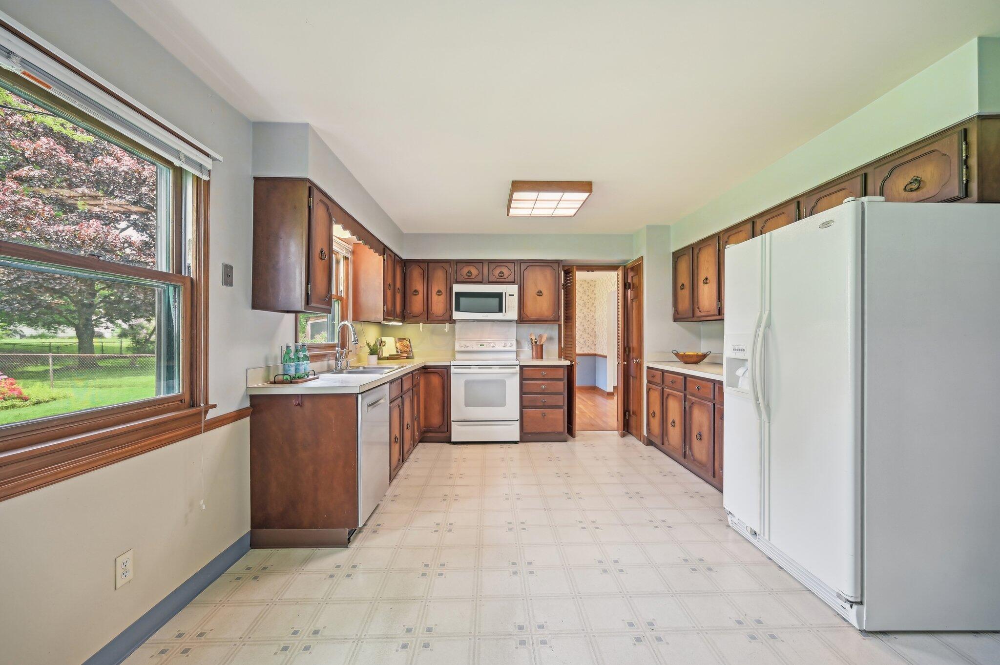 5917 Rocky Rill Road Columbus, OH 43235 - Photo 11 of 47 Kitchen with Ample Cabinetry
Generously sized kitchen with classic wood cabinetry, ample counter space, and stainless steel dishwasher. Large window provides natural light and a view of the backyard.