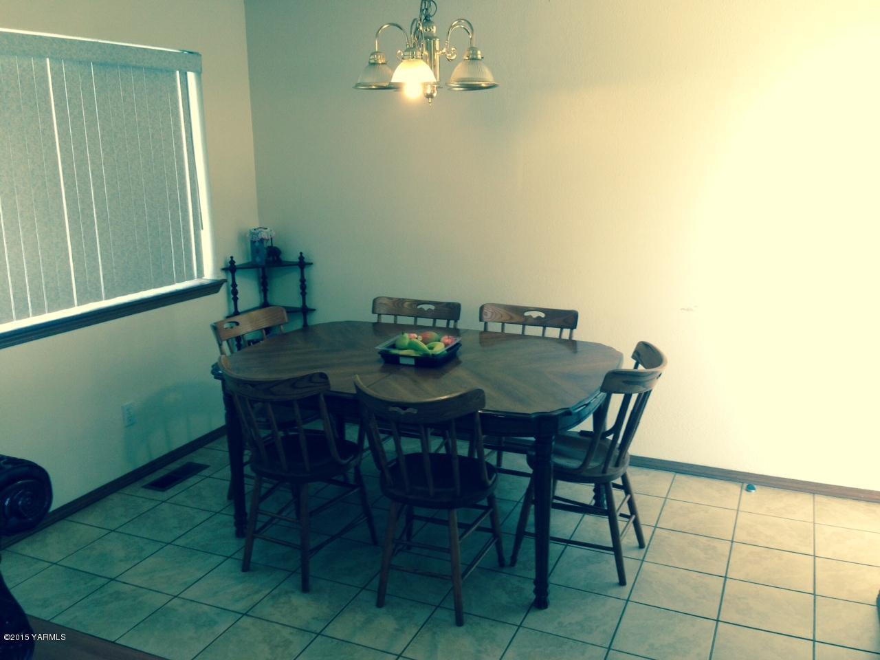 1455 Maple Grove Road Sunnyside, WA 98944 - Photo 8 of 17 a view of a dining room with furniture and chandelier