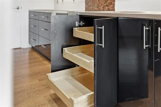 walk in closet with wooden floor