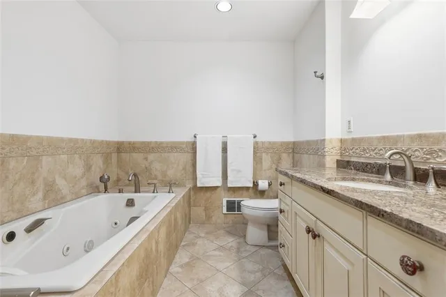 a bathroom with a tub a sink and a large window