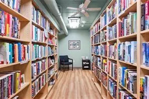 a view of living room with furniture and book shelf