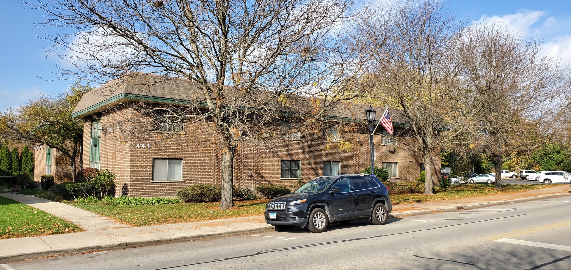 444 Spring Road, Unit 1 Elmhurst, IL 60126 - Photo 1 of 14 a car parked on the side of a street