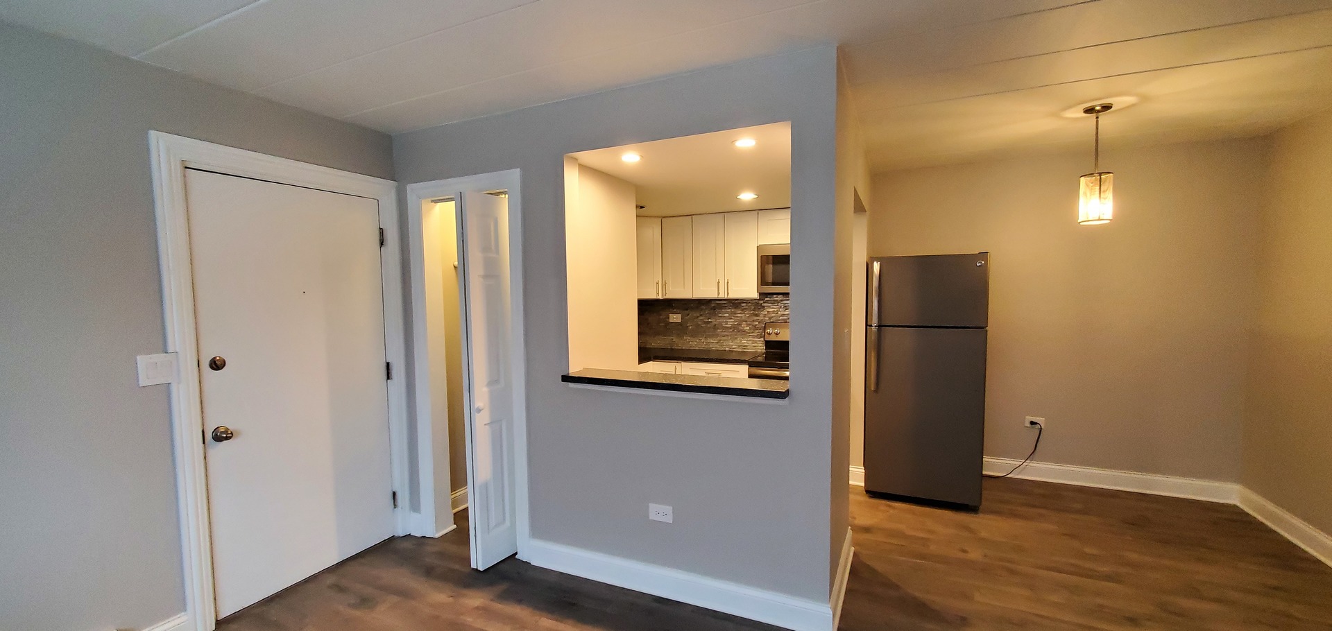 444 Spring Road, Unit 1 Elmhurst, IL 60126 - Photo 4 of 14 a view of a kitchen with a refrigerator and a sink