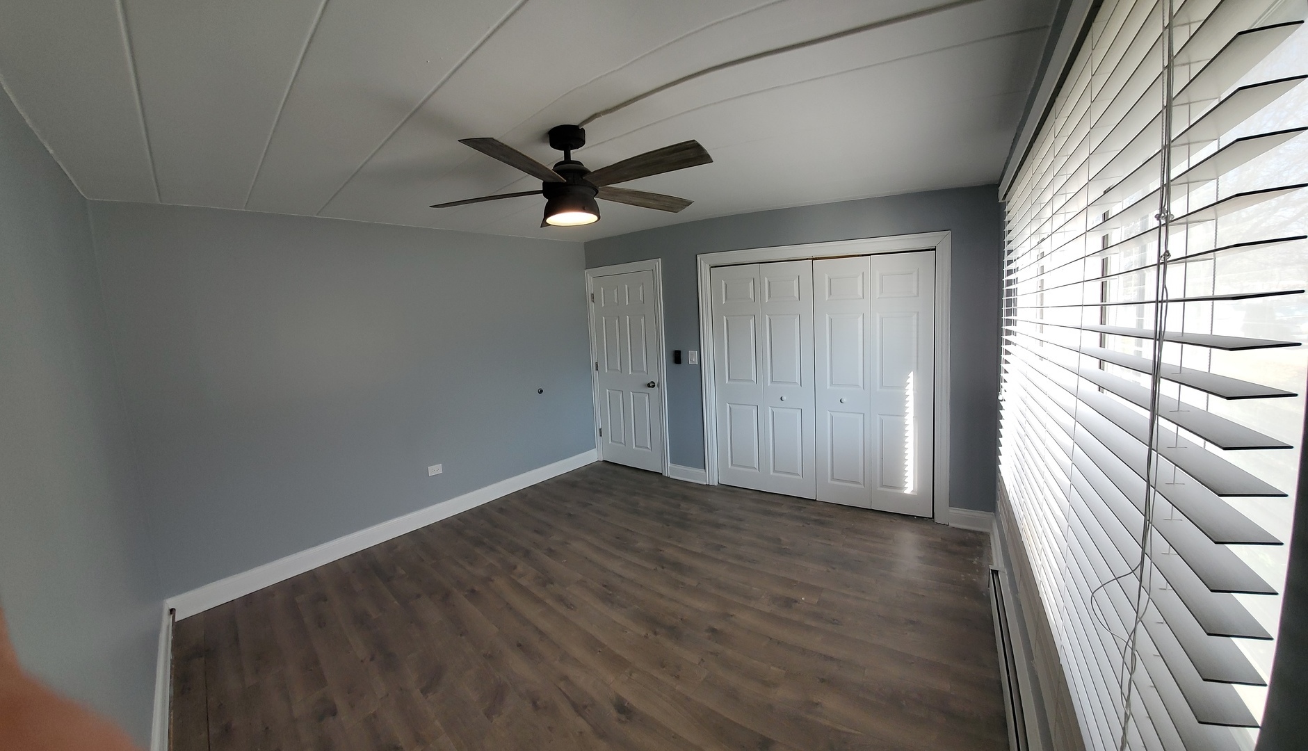 444 Spring Road, Unit 1 Elmhurst, IL 60126 - Photo 8 of 14 a view of empty room with wooden floor and fan
