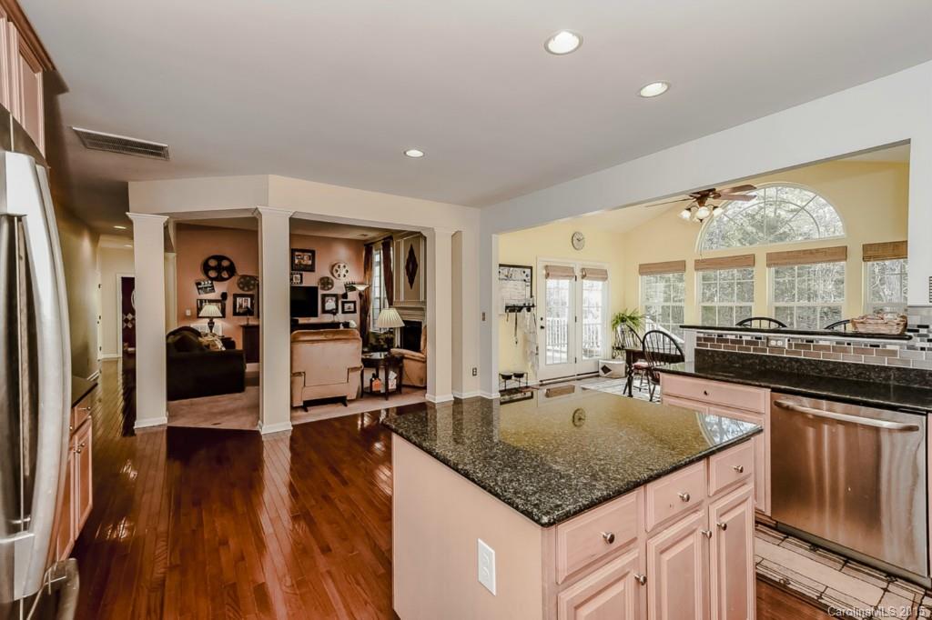 315 Calming Way Tega Cay, SC 29708 - Photo 11 of 24 a kitchen with a counter top space a sink a refrigerator and wooden floor