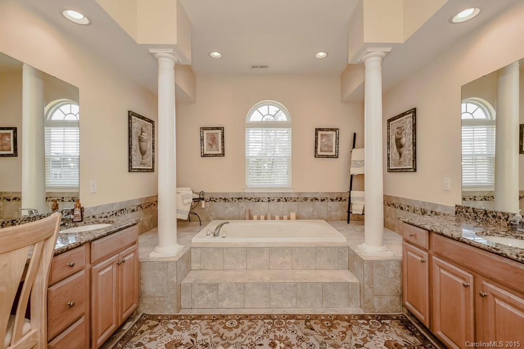 315 Calming Way Tega Cay, SC 29708 - Photo 16 of 24 a spacious bathroom with a tub sink and mirror