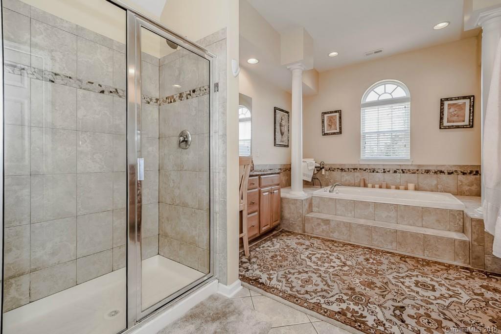 315 Calming Way Tega Cay, SC 29708 - Photo 17 of 24 a bathroom with a bathtub and a shower