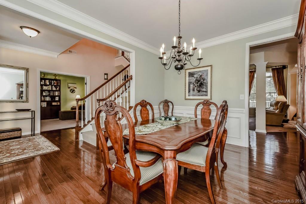 315 Calming Way Tega Cay, SC 29708 - Photo 6 of 24 a view of a a dining room and livingroom with furniture wooden floor a chandelier