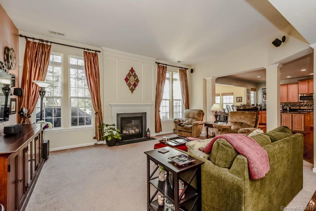 315 Calming Way Tega Cay, SC 29708 - Photo 7 of 24 a living room with furniture large window and a fireplace