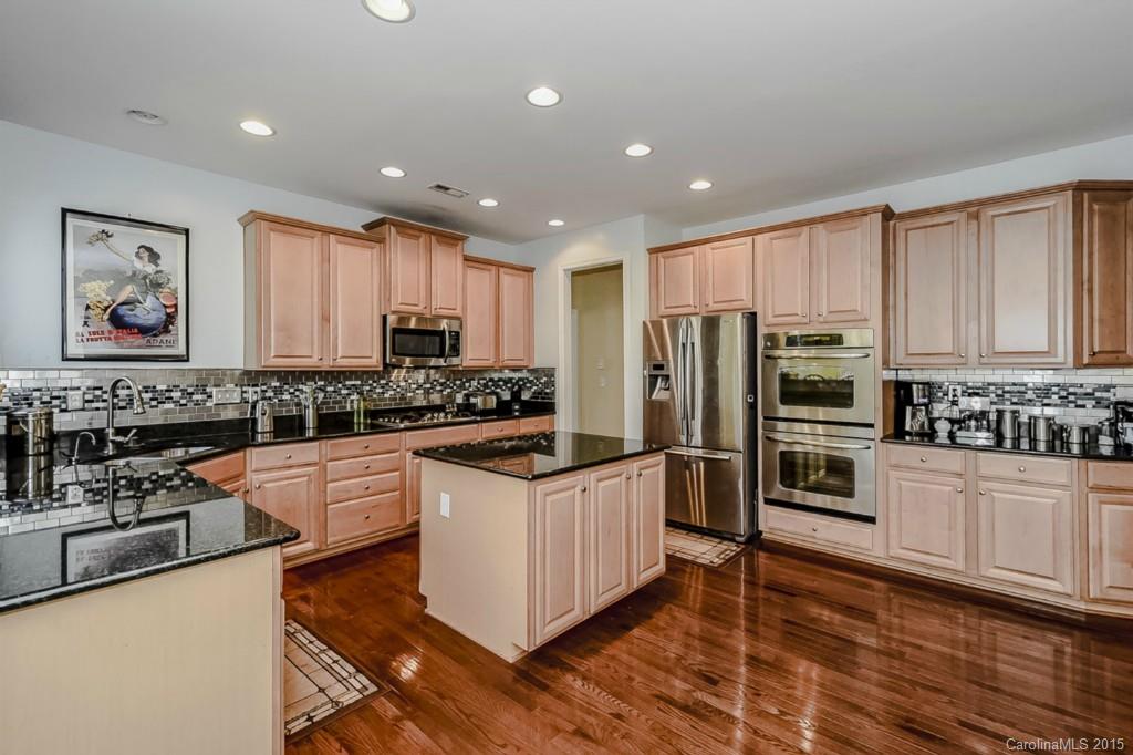 315 Calming Way Tega Cay, SC 29708 - Photo 10 of 24 a kitchen with stainless steel appliances and wooden cabinets