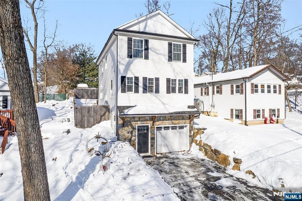 506 Brooklyn Mountain Road Hopatcong, NJ 07843 - Photo 1 of 30 a front view of a house with a yard covered with snow in front of house