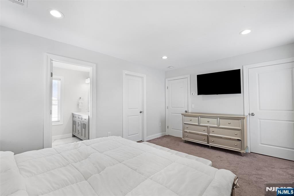 506 Brooklyn Mountain Road Hopatcong, NJ 07843 - Photo 11 of 30 a bedroom with a bed and a flat screen tv