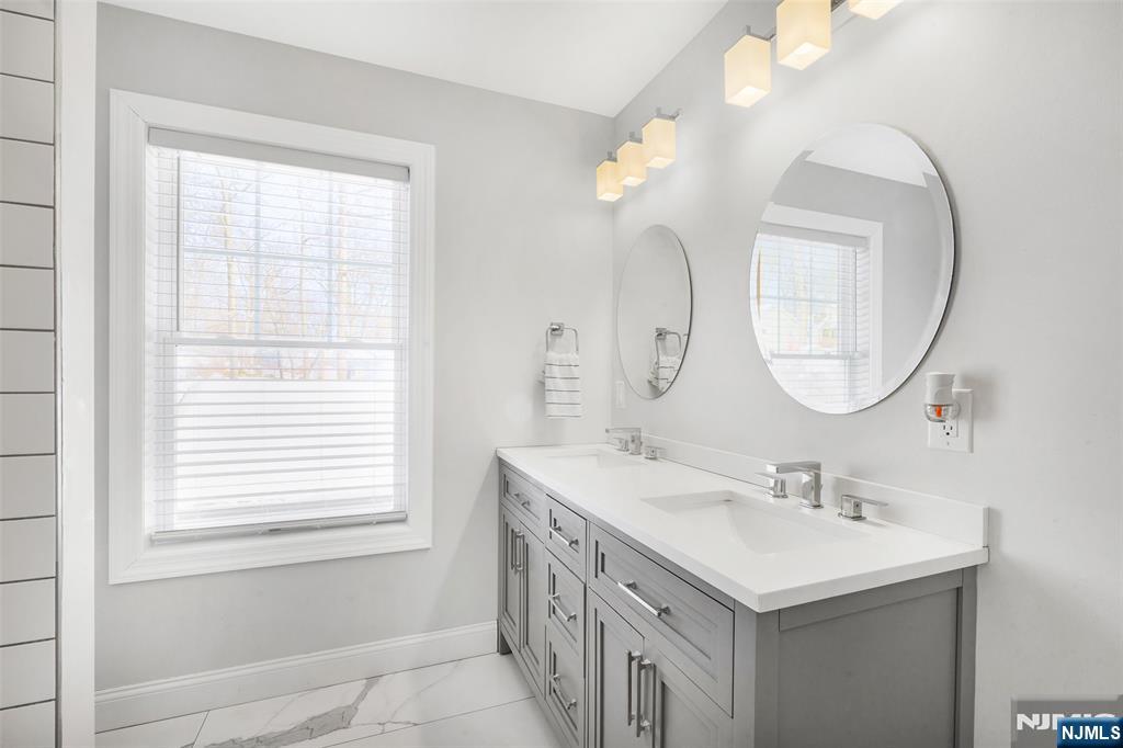506 Brooklyn Mountain Road Hopatcong, NJ 07843 - Photo 12 of 30 a bathroom with a double vanity sink and a mirror